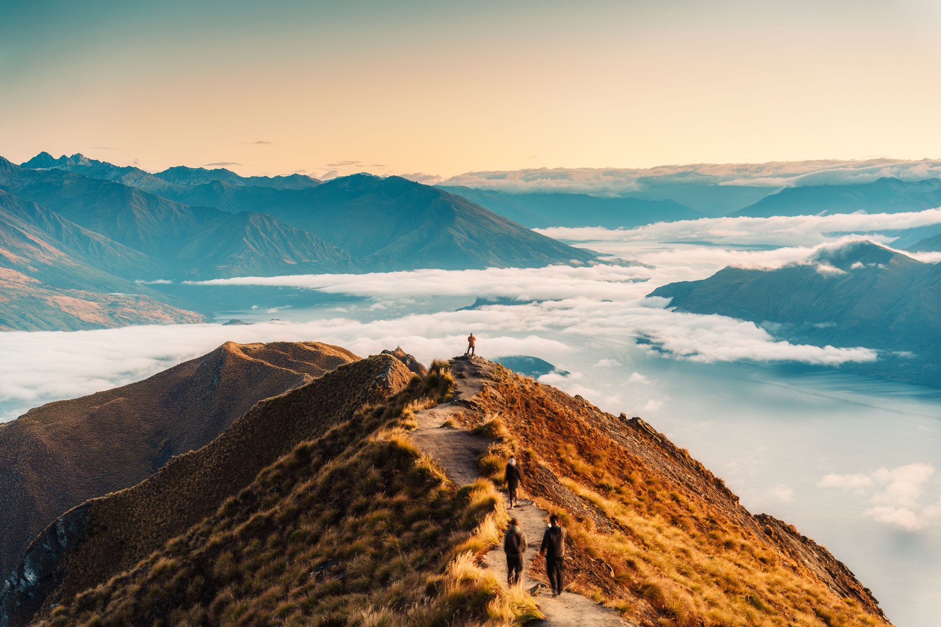 Landscape of Roys Peak summit with foggy mountain and tourist enjoying in autumn at New Zealand
